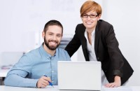 Businessman And Businesswoman With Laptop